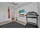 Exercise room with modern treadmill, mounted TV, and minimalist design details at 25062 Palisade Rd, Punta Gorda, FL 33983