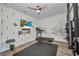 Home gym featuring a treadmill, mounted TV, and sleek design elements at 25062 Palisade Rd, Punta Gorda, FL 33983