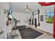 Bright exercise room featuring a treadmill, weight rack, and ceiling fan at 25062 Palisade Rd, Punta Gorda, FL 33983
