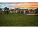 Beautiful single-story home featuring a well-manicured lawn, neutral tones, and a spacious three-car garage at 25062 Palisade Rd, Punta Gorda, FL 33983