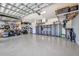 Organized three car garage with epoxy flooring, storage cabinets, and overhead storage racks at 25062 Palisade Rd, Punta Gorda, FL 33983