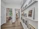 Hallway gallery showcasing artwork, leading to bedroom and other rooms at 25062 Palisade Rd, Punta Gorda, FL 33983