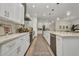 Modern kitchen featuring white cabinetry, stainless steel appliances, and a view into the dining area at 25062 Palisade Rd, Punta Gorda, FL 33983