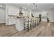 Expansive kitchen island provides seating, stylish lighting, and plenty of countertop space for food preparation at 25062 Palisade Rd, Punta Gorda, FL 33983