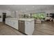 Bright and open kitchen with large island, stainless steel appliances, and seamless flow to the living area at 25062 Palisade Rd, Punta Gorda, FL 33983