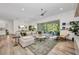 Living room showcases a spacious sectional sofa, light wood floors, and view of backyard patio at 25062 Palisade Rd, Punta Gorda, FL 33983