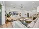 Living area with modern decor, a large sectional sofa, and a view into the kitchen at 25062 Palisade Rd, Punta Gorda, FL 33983