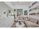 Bright, modern living room with a comfortable sectional sofa, artwork, and a view from the window at 25062 Palisade Rd, Punta Gorda, FL 33983