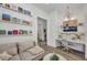 Inviting living room area with a comfy sofa, bookshelves, and a dedicated workspace at 25062 Palisade Rd, Punta Gorda, FL 33983