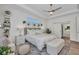 Bright main bedroom with tray ceiling, ceiling fan, and plush decor and furnishings at 25062 Palisade Rd, Punta Gorda, FL 33983