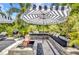 Comfortable patio seating by a fire pit with the grill nearby offers a relaxing outdoor space for cooking and entertaining at 25062 Palisade Rd, Punta Gorda, FL 33983