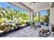 Covered outdoor patio with built-in seating, landscaping, and access to outdoor fire pit area at 25062 Palisade Rd, Punta Gorda, FL 33983
