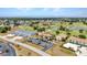 Scenic aerial view showcases a community with golf course, pond, and well-maintained buildings and landscaping at 26336 Nadir Rd # 10, Punta Gorda, FL 33983