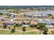 Aerial view showcases the community, water feature, landscaping, and golf course at 26336 Nadir Rd # 10, Punta Gorda, FL 33983