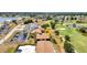 Aerial view of condo building next to golf course and lake in residential neighborhood at 26336 Nadir Rd # 10, Punta Gorda, FL 33983