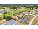 Aerial view showcases the community, pond, golf course, and manicured landscaping at 26336 Nadir Rd # 10, Punta Gorda, FL 33983