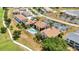 Aerial view of condos with parking and a pool in a golf course community at 26336 Nadir Rd # 10, Punta Gorda, FL 33983