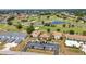 Aerial view of condos with parking in a community on a golf course with ponds at 26336 Nadir Rd # 10, Punta Gorda, FL 33983