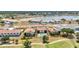 An aerial view highlights community buildings, golf course, and lake at 26336 Nadir Rd # 10, Punta Gorda, FL 33983