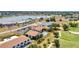 A high-angle aerial view features the buildings, pool, and golf course at 26336 Nadir Rd # 10, Punta Gorda, FL 33983