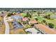 This aerial view showcases buildings, golf course, ponds, and parking at 26336 Nadir Rd # 10, Punta Gorda, FL 33983