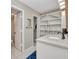 Bathroom featuring quartz countertop, built-in shelving and open entry to closet at 26336 Nadir Rd # 10, Punta Gorda, FL 33983