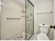 Bathroom featuring ceramic tile shower with glass doors and a low-flow toilet at 26336 Nadir Rd # 10, Punta Gorda, FL 33983