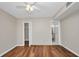 Light and airy bedroom with modern hard wood floors, ceiling fan and access to bathroom at 26336 Nadir Rd # 10, Punta Gorda, FL 33983