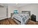 Cozy bedroom with wood laminate flooring, neutral paint, and a queen-sized bed at 26336 Nadir Rd # 10, Punta Gorda, FL 33983