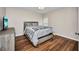 Cozy bedroom with wood laminate flooring, neutral paint, and a queen-sized bed at 26336 Nadir Rd # 10, Punta Gorda, FL 33983