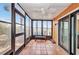 Sunroom with tiled floors and screens offering views to outdoor landscaping and nature at 26336 Nadir Rd # 10, Punta Gorda, FL 33983
