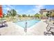 Outdoor community pool surrounded by lush landscaping and comfortable seating for residents at 26336 Nadir Rd # 10, Punta Gorda, FL 33983