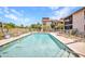 Community pool with ample lounge chairs and serene views, perfect for enjoying sunny days at 26336 Nadir Rd # 10, Punta Gorda, FL 33983