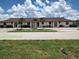 Low-rise condo building with beige stucco and terra cotta tile roof, palm trees and lush green landscaping at 2732 Magdalina Dr # C, Punta Gorda, FL 33950