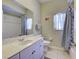 Bright bathroom featuring a white vanity, large mirror, and a shower/tub combination at 2969 Wells Ave, North Port, FL 34286