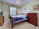 Comfortable bedroom with a large window and wood furniture at 2969 Wells Ave, North Port, FL 34286