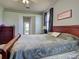 Comfortable bedroom with ceiling fan, wood furniture and a doorway leading to an ensuite bathroom at 2969 Wells Ave, North Port, FL 34286