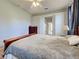 Comfortable bedroom with ceiling fan, wood furniture and a doorway leading to an ensuite bathroom at 2969 Wells Ave, North Port, FL 34286