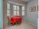 Cozy breakfast nook with a table, chairs, and bright natural light from the bay windows at 2969 Wells Ave, North Port, FL 34286