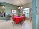 The dining room features natural light, tiled floors, traditional furniture and a chandelier at 2969 Wells Ave, North Port, FL 34286