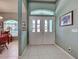 Inviting foyer featuring tile flooring, a double-door entry, and views into the dining area at 2969 Wells Ave, North Port, FL 34286