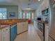 Well-lit kitchen with stainless steel appliances, white cabinets, and a breakfast nook with plantation shutters at 2969 Wells Ave, North Port, FL 34286