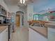 Open concept kitchen with stainless steel appliances and tile flooring, perfect for cooking and entertaining at 2969 Wells Ave, North Port, FL 34286