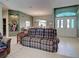 Open-concept living room showcasing tile flooring, comfortable seating, and a clear view of the entry at 2969 Wells Ave, North Port, FL 34286