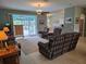Open living room with tile floors, comfortable furniture, and a ceiling fan for climate control at 2969 Wells Ave, North Port, FL 34286