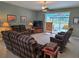 Spacious living room featuring a ceiling fan, comfortable seating, and access to the lanai at 2969 Wells Ave, North Port, FL 34286