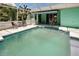 Backyard swimming pool and screened-in patio offers a great outdoor space at 2969 Wells Ave, North Port, FL 34286