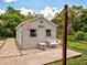 Exterior of the backyard shed with a wicker bench and table in front at 2969 Wells Ave, North Port, FL 34286
