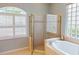 Well-lit bathroom showcasing a glass shower and soaking tub with privacy window at 421 Marsh Creek Rd, Venice, FL 34292
