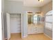 Bright bathroom with double sinks and window plus a walk-in closet with shelving at 421 Marsh Creek Rd, Venice, FL 34292